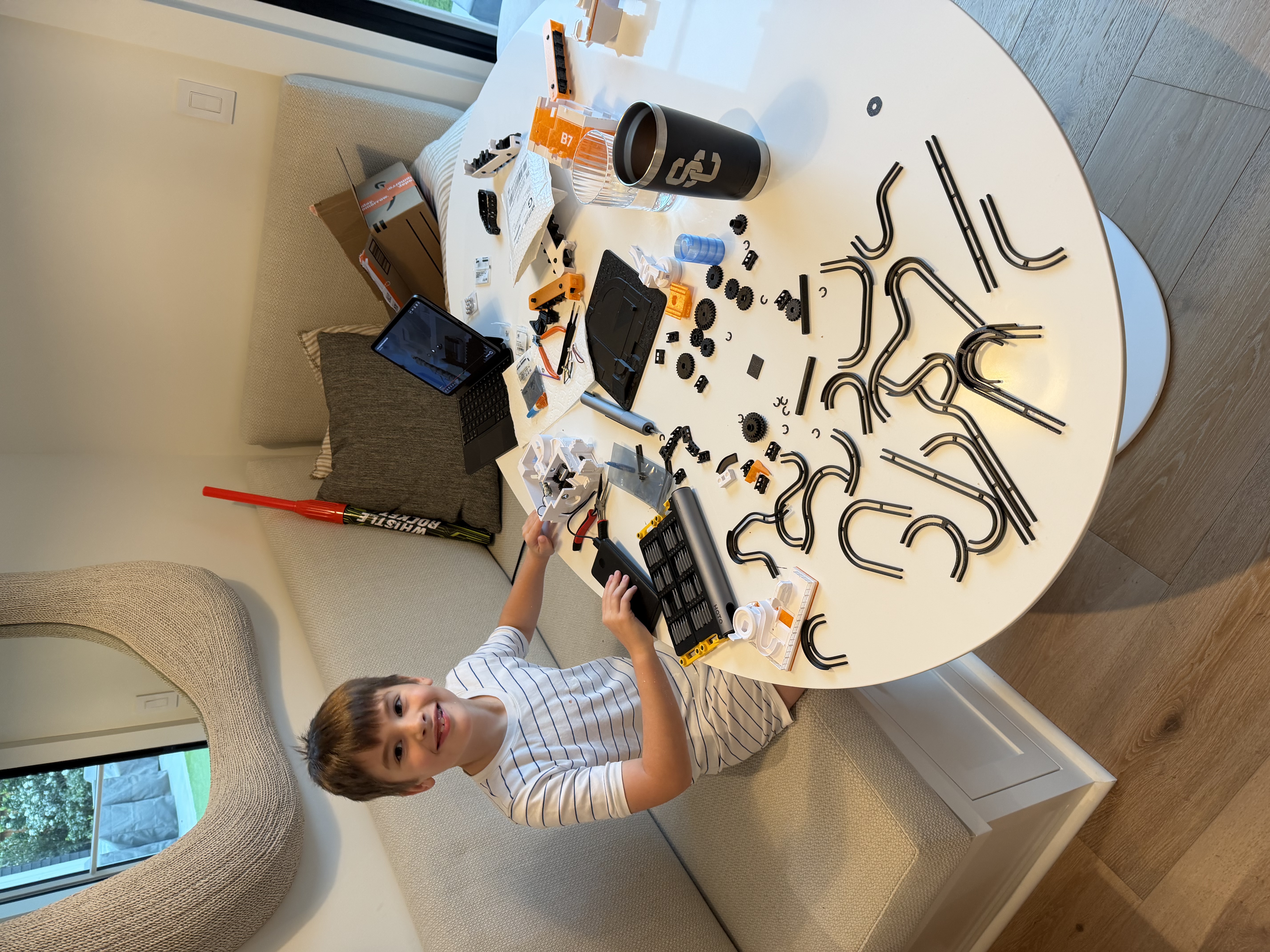 Luke building RC car tracks at the table