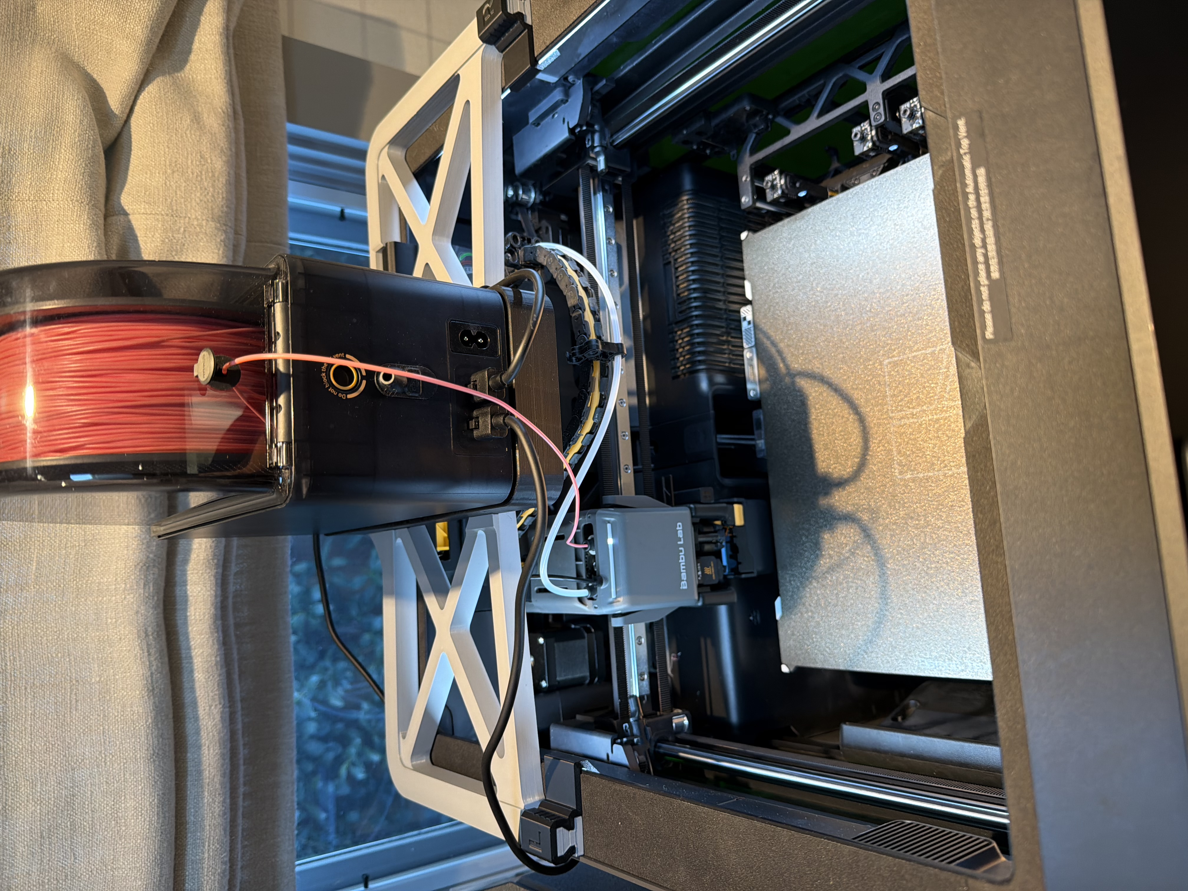 Bambu Lab printer with red filament