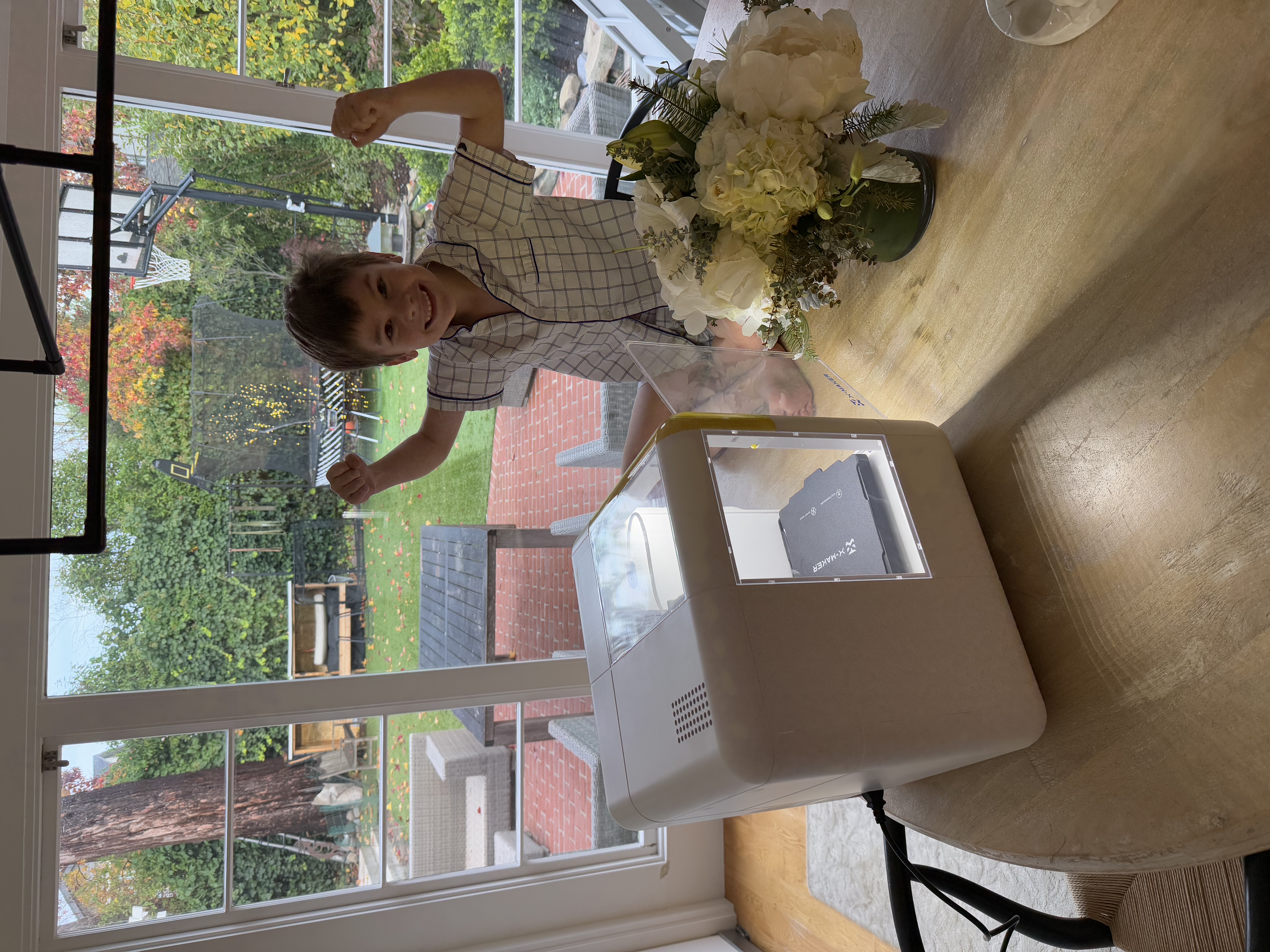 Luke celebrating with arms up next to his first printer