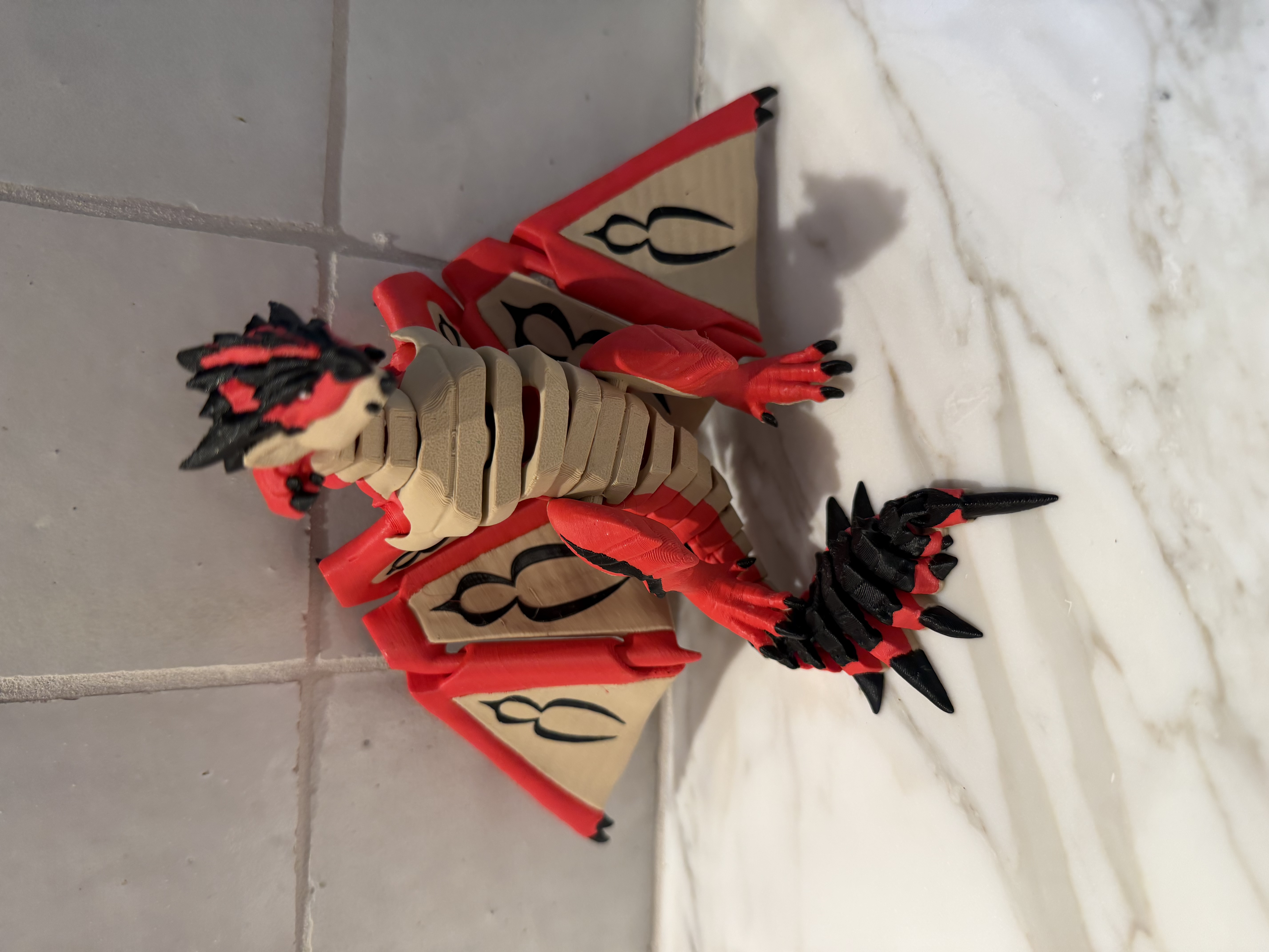3D printed articulated red and black dragon figurine