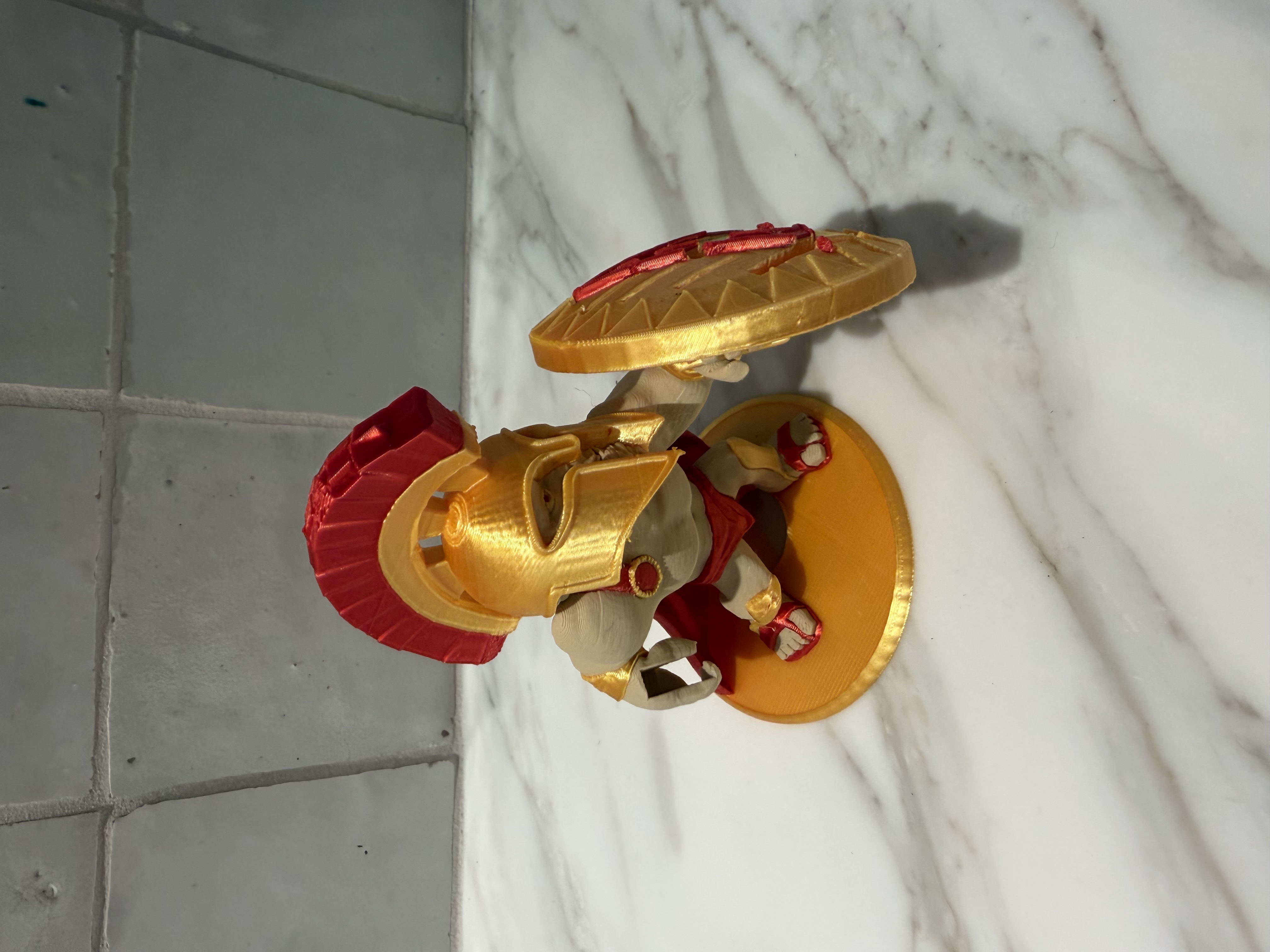 3D printed Spartan warrior figurine in gold and red