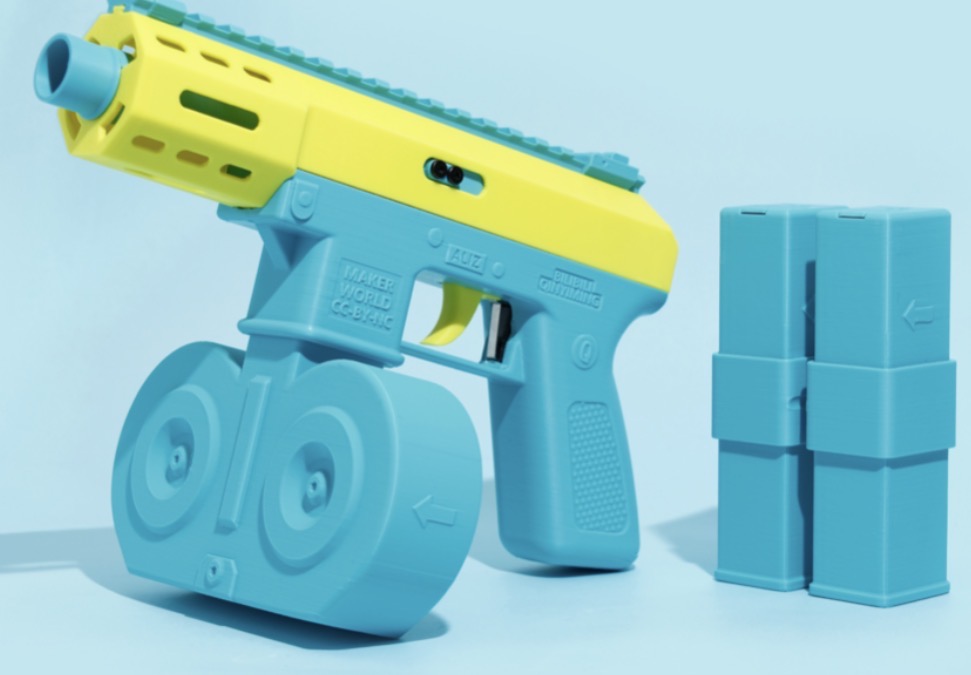 3D printed water gun in yellow and blue with drum magazine